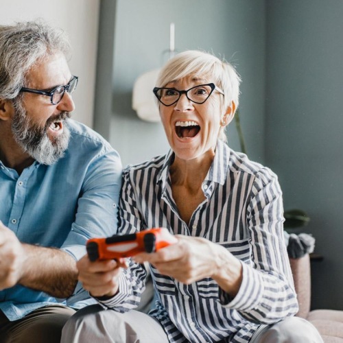 a man and a woman laughing playing video games